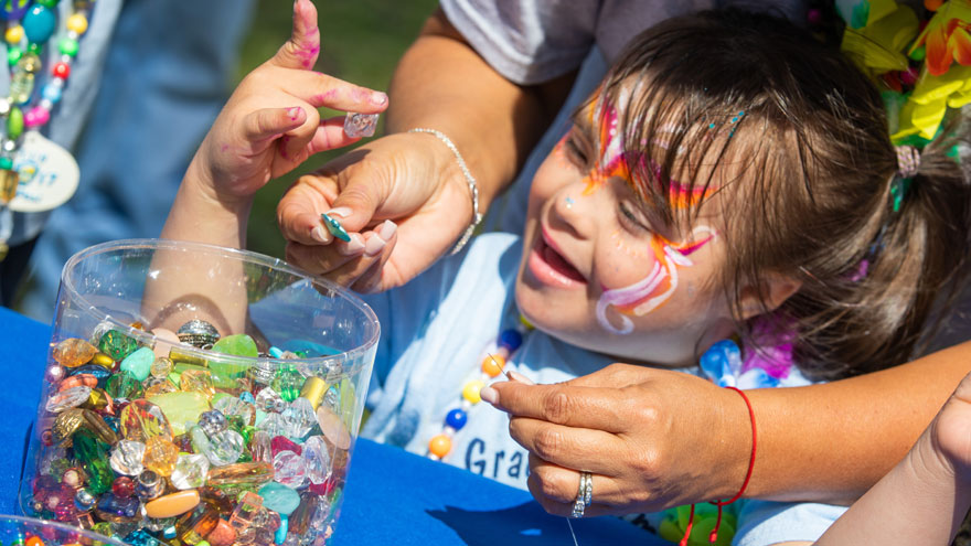 girl playing with colorful stones